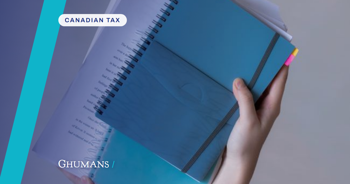 Hands hold blue spiral-bound notebooks and papers, showcasing organization and study.